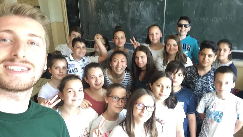 Bryce with students in Romania