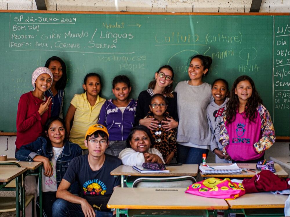 An exchange participant with students in a classroom