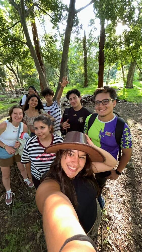 Exchange participants and local friends taking a group selfie