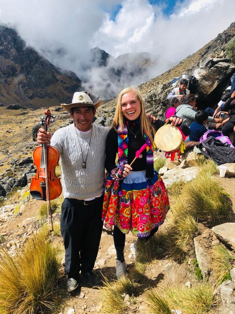 An exchange participant with local musicians in the mountains