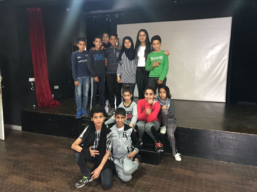 Varinda with students on stage in Morocco